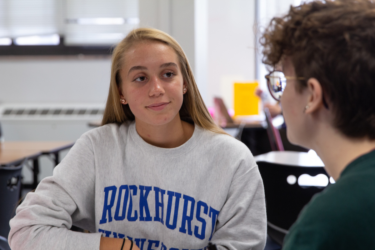 Learning Center tutor talks with a fellow student