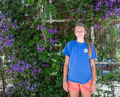 Hannah Nelligan stands in front of pergola