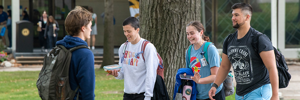 Students walking across campus, laughing