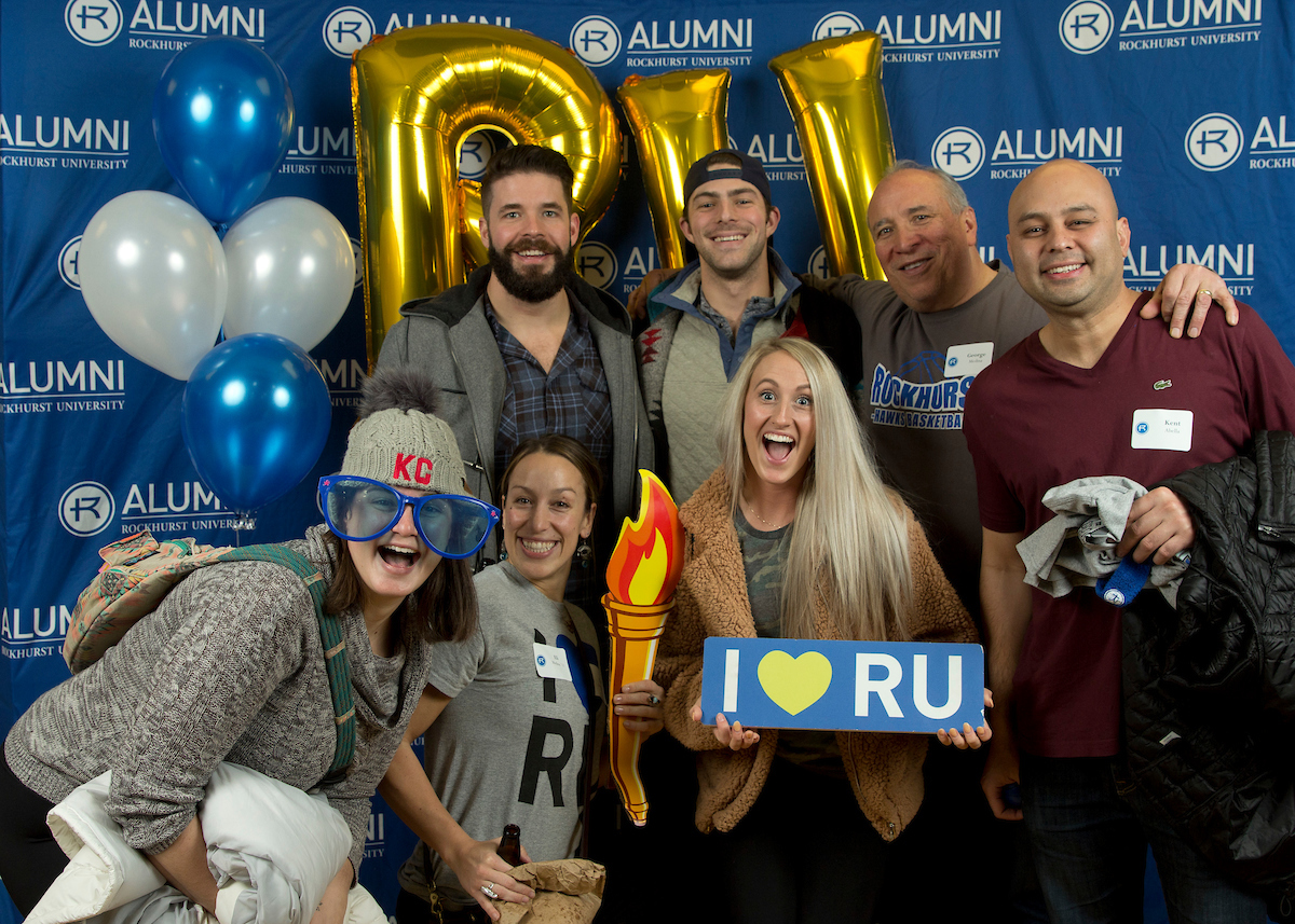 Group of RU alumni with RU spirit props