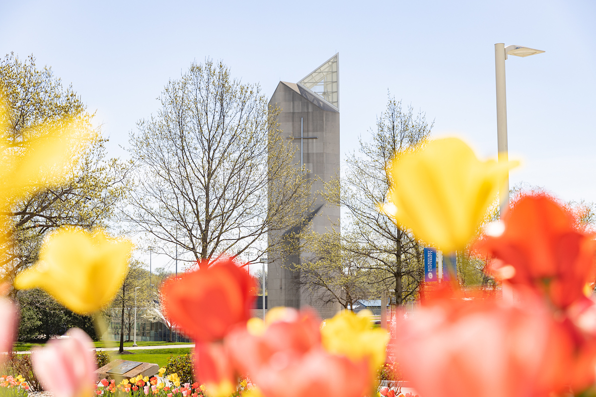 Rockhurst bell tower with colorful spring tulips in the foreground