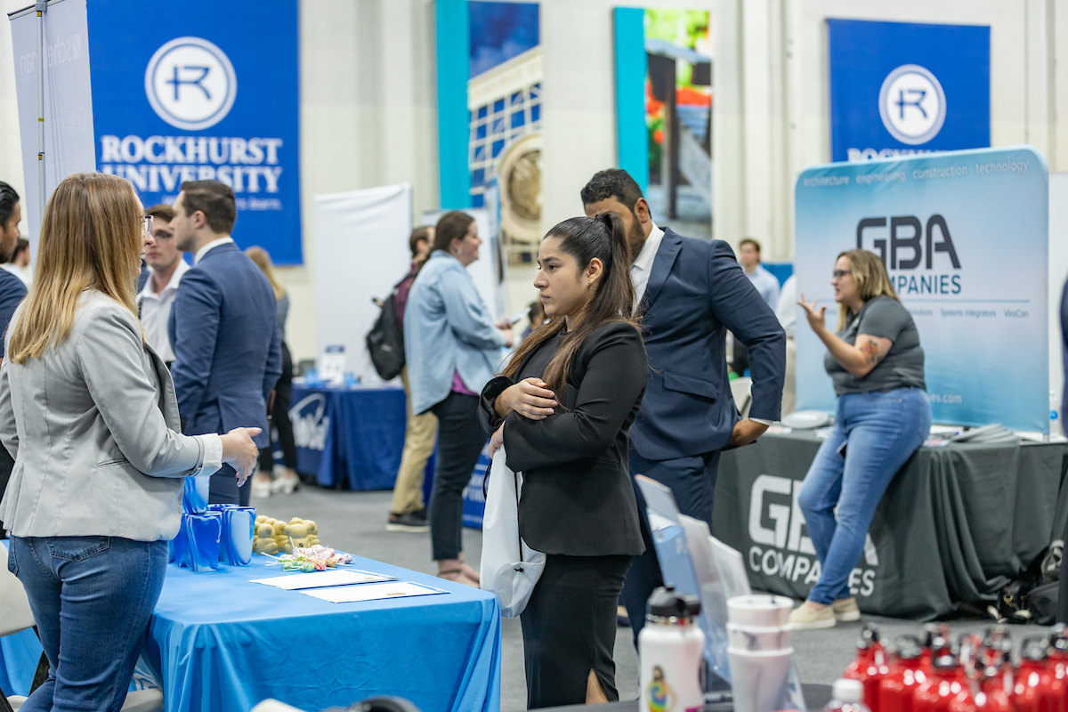 A student talks with a business rep at Rockhurst University's career expo