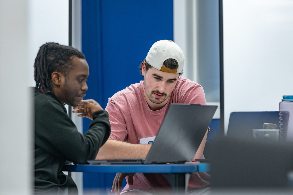 two students studying at a laptop