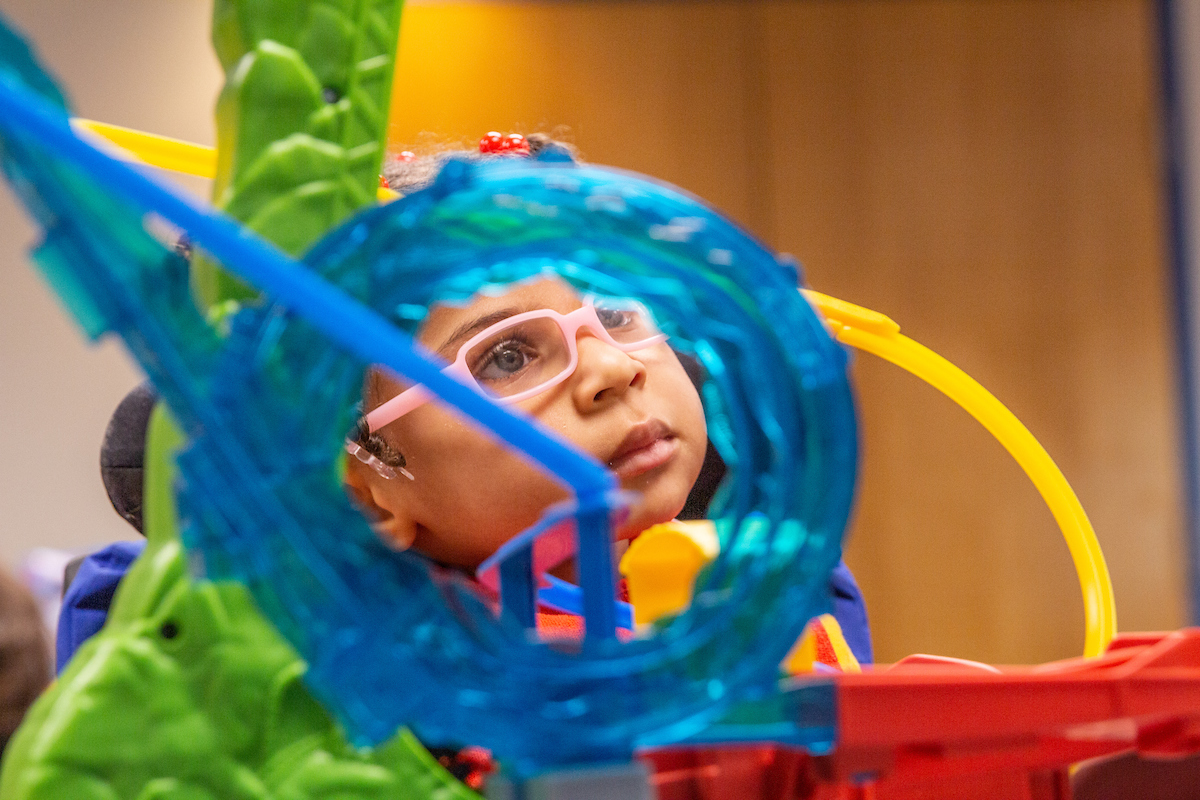 A child is viewed through a toy at AbilityKC during OT fieldwork