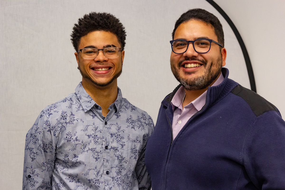 Two students smile at the camera