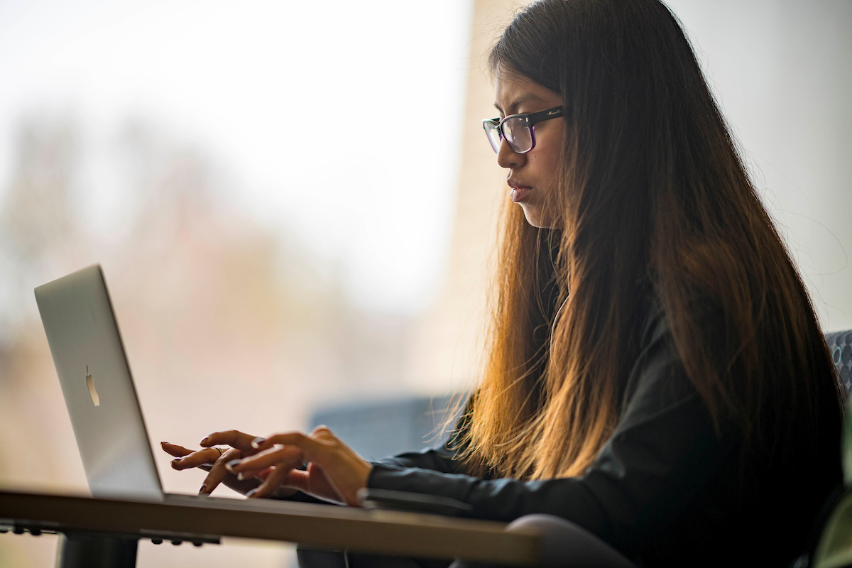 A student types on a laptop