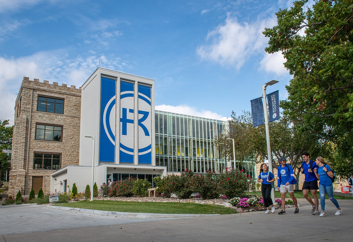 Four students walk in front of Sedgwick Hall