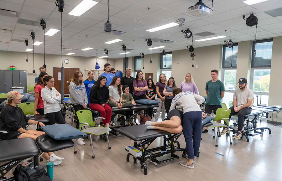 PT instructor demonstrates a technique on a student for her class