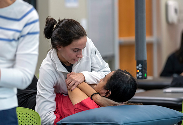 A PT instructor practices a technique on a student