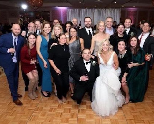 Bride, Groom, ang guests at a wedding.