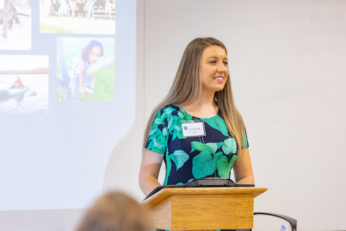 A woman speaks from the podium at Leadership & Ethics Day at Rockhurst University 