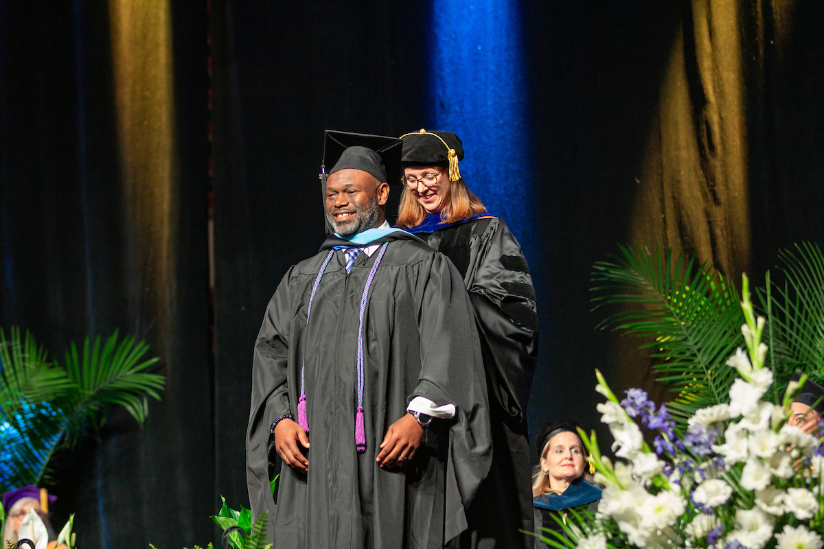 An Education grad student gets hooded at Rockhurst University commencement