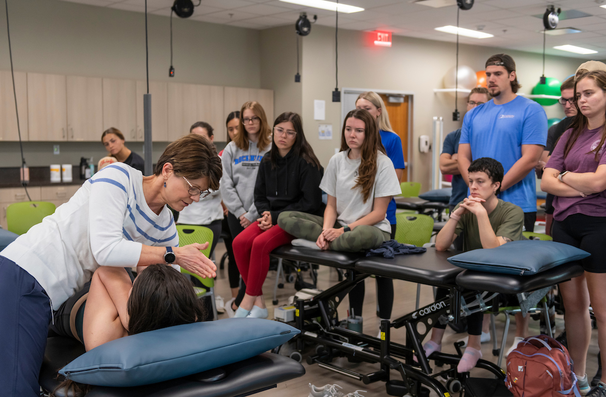 PT instructor demonstrates a technique on a student for her class