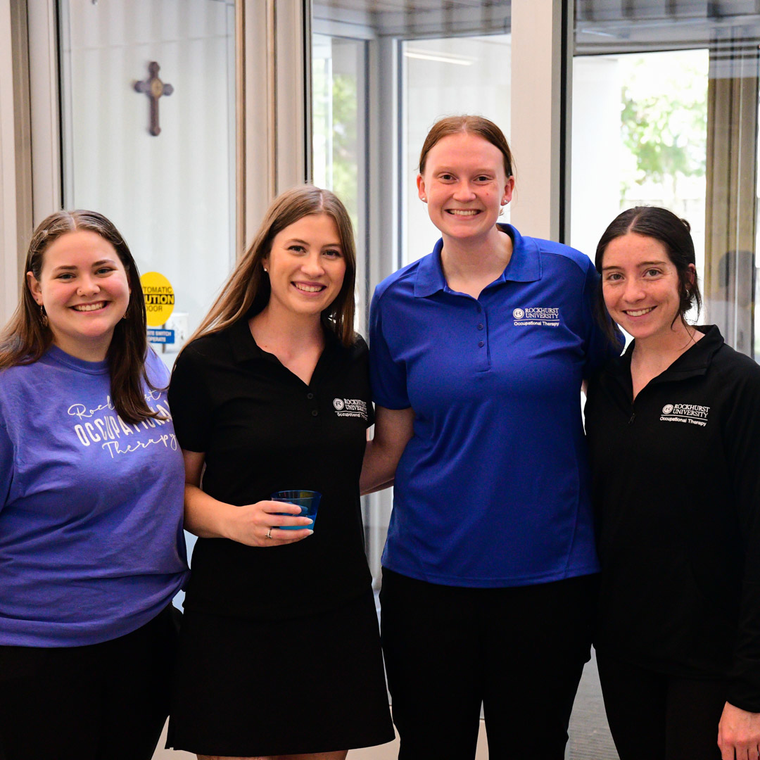 Four OT students pose for the camera at an event