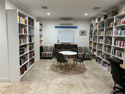 A table is surrounded by bookshelves at the new Marcel Institute at the Catholic Institute of Sydney, Australia