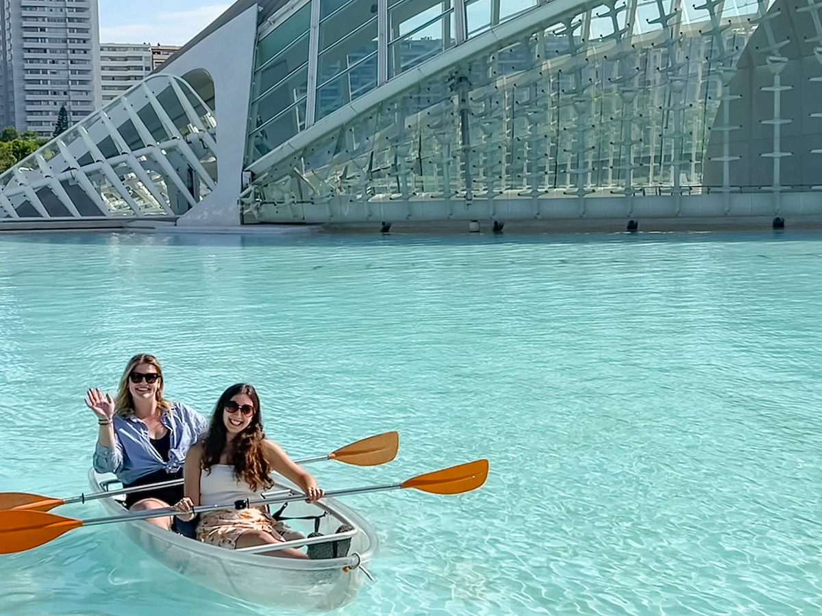 Two female students paddle in a clear canoe in Spain 2023