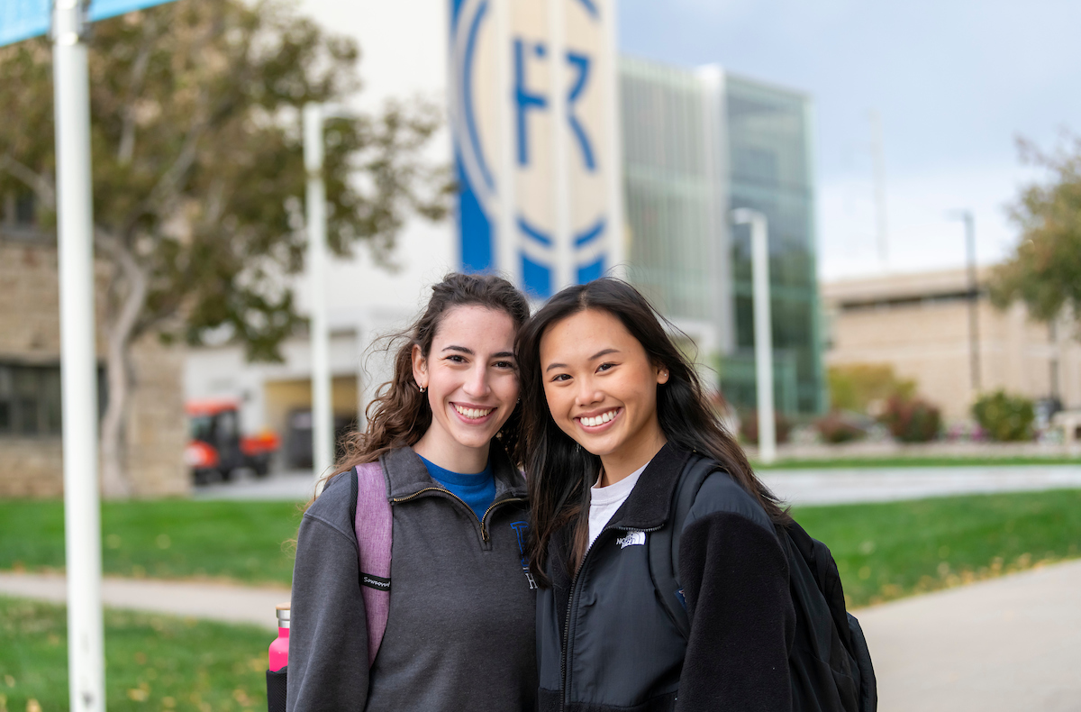 Two students smiling on campus