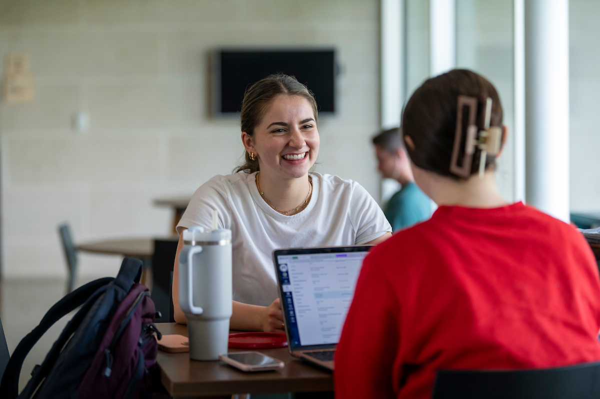 Student smiling in Arrupe Hall