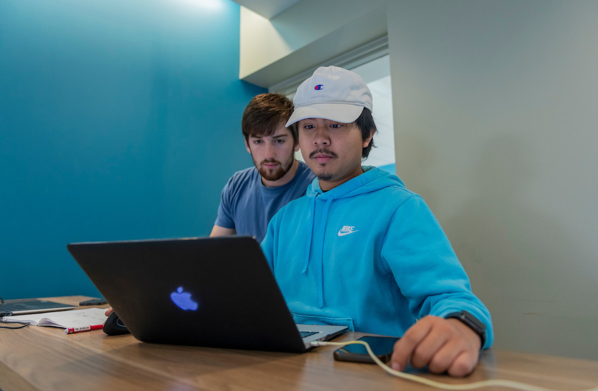 Two males studying in Arrupe Hall