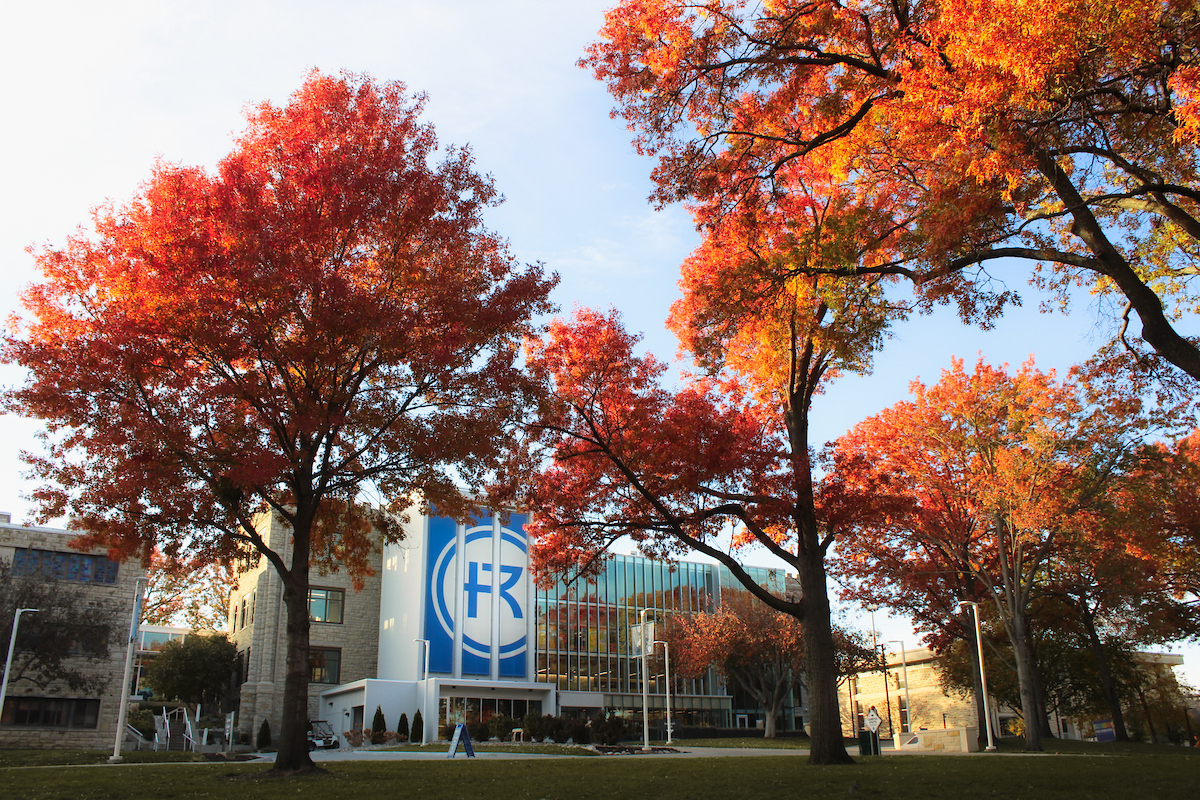 Sedgwick Hall in fall. Trees with bright red leaves. 