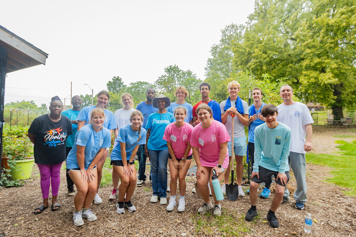 A group photo of Finucane service project student workers and community members