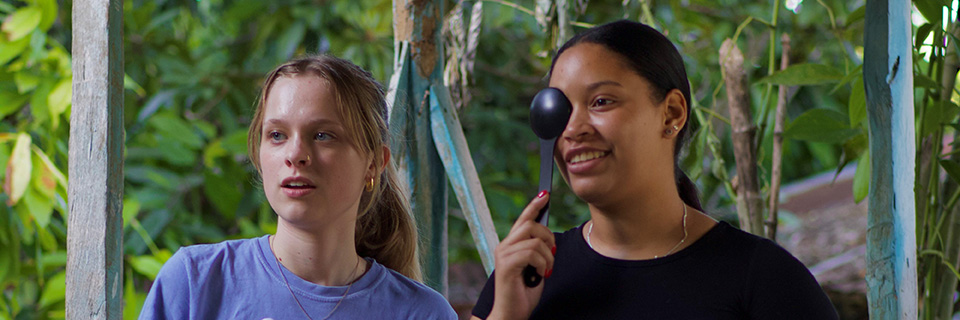 A student administers an eye exam to another student