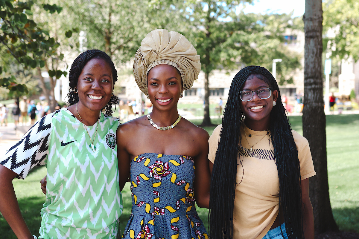 3 students pose for the camera at World Cultures Day 2024