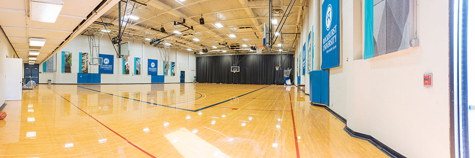 Empty Convocation Center (basketball floor, wall banners)