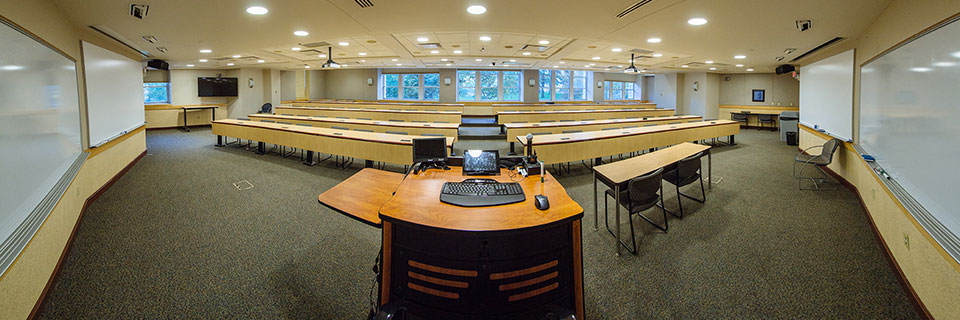 View from the front of Conway 103 (computer podium with rows of desks) 