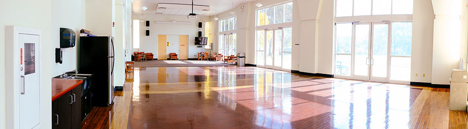 Open floor of Student Activity Hall with wall of windows 