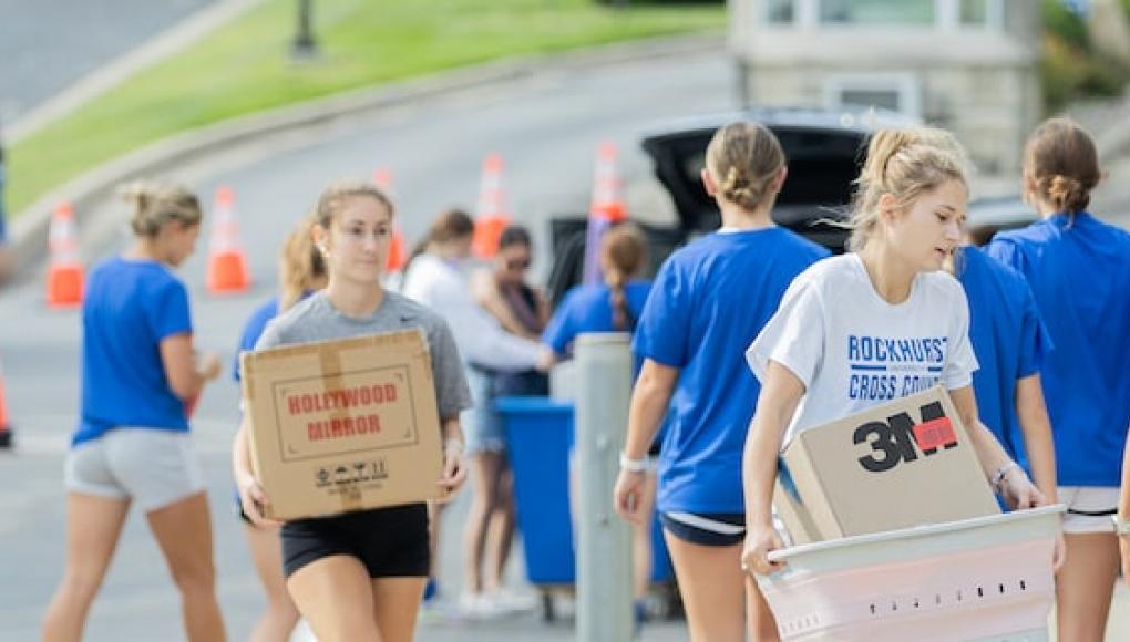 Students helping new students move in