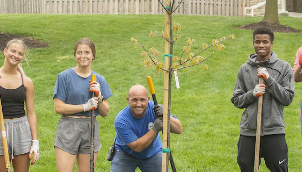 Students and staff after planting a tree on campsu