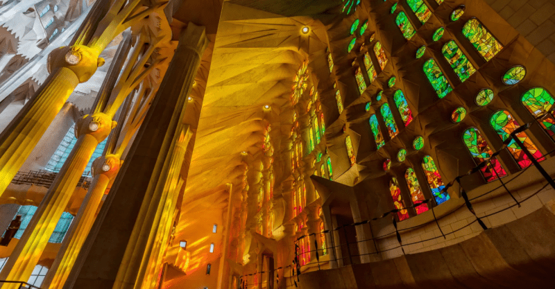 Colorful inside of a cathedral with sun coming through stained glass
