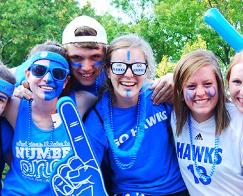 Six students in Rockhurst blue spirit wear smiling