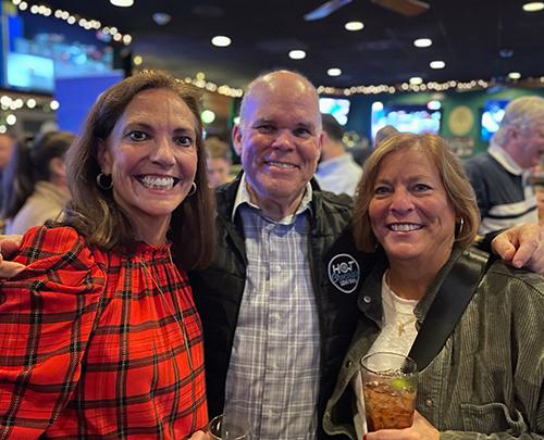 Three alums pose for the camera