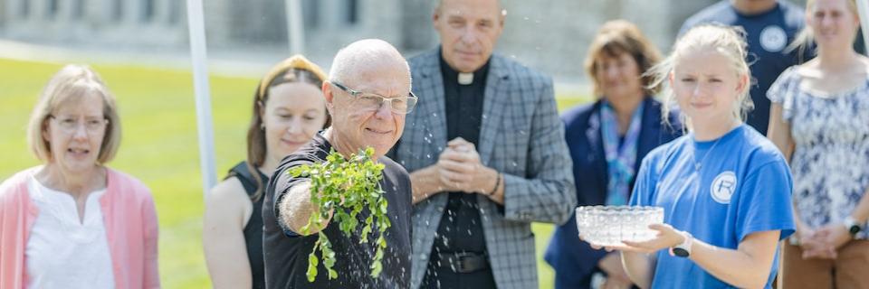 Members of the Hageman Family bless a new campus site in honor of their son
