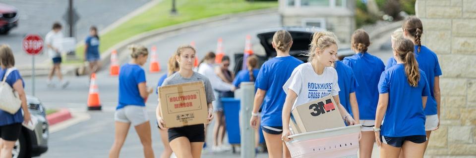 Students helping new students move in