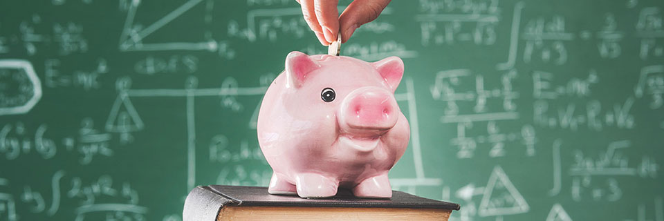 Piggy bank in front of chalkboard